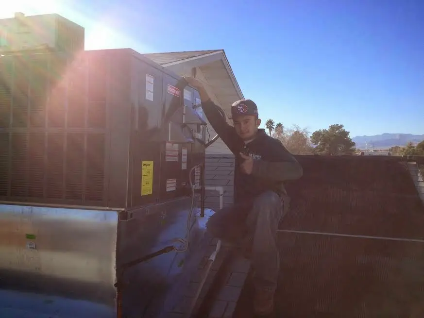 HVAC technician performing HVAC Inspection on a rooftop unit in Maltby
